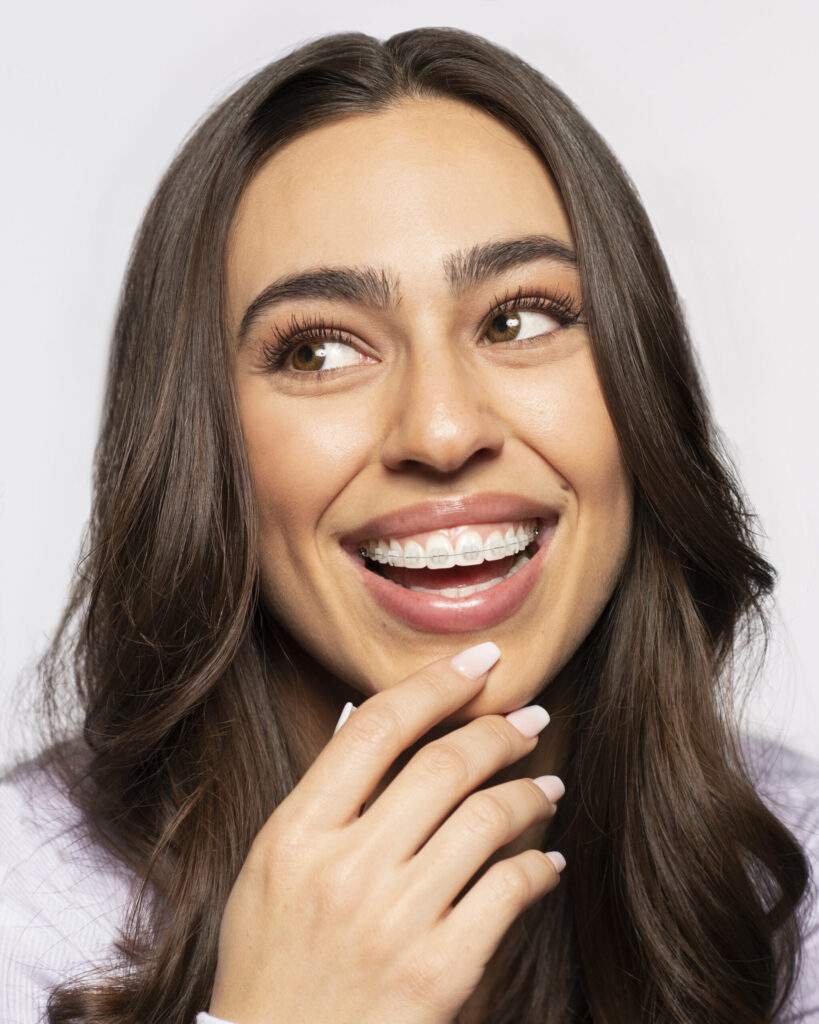Smiling patient wearing LightForce clear braces, treated by Dr. Ken Lawrence serving Kirtland, OH